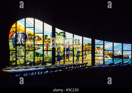 Abidjan, Ivory Coast, Cote d'Ivoire.  Stained Glass Window Showing Arrival of First Missionaries at Grand Bassam in 1895.  Designed by Aldo Spirito.  FOR EDITORIAL USE ONLY. Stock Photo