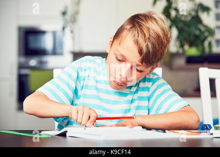 Little boy writing his homework for elementary school. Stock Photo