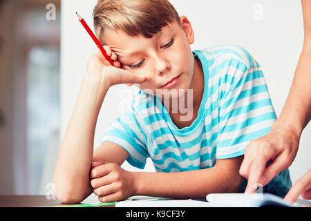 Little boy writing his homework for elementary school. Stock Photo