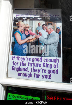 pasty shop poster. showing HRH Charles receiving a Cornish pasty. 'if they're good enough for the future king of England, they're good enough for you !' Stock Photo