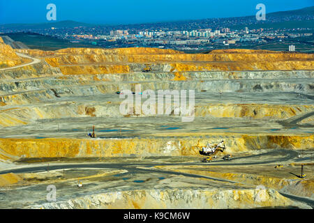 Benches of an open-pit copper mine of the Erdenet Mining Corporation EMC, city of Erdenet behind, Erdenet, Mongolia