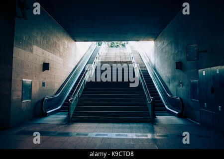 Exit with escalator from the underground metro. Light at the end of the tunnel concept Stock Photo