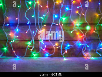 Christmas lights on wooden background. Decorative garland Stock Photo