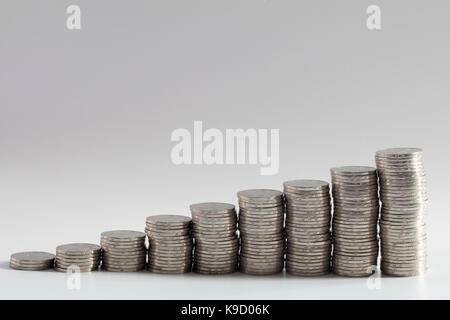 stacks of coins in ascending numbers from left to right symbolizing growing or increasing wealth, investments, savings, riches or general improvement Stock Photo