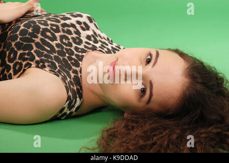 Beautiful girl with long wavy hair. Isolated on green Stock Photo