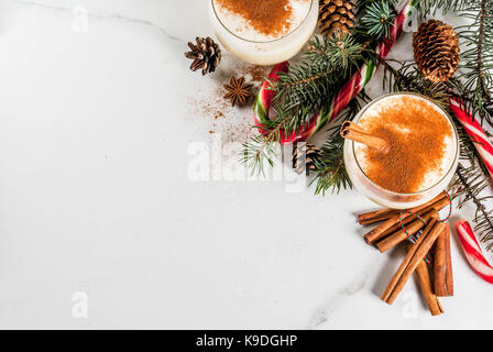 Eggnog with cinnamon and nutmeg for Christmas and winter holidays. Homemade  eggnog in glasses on wooden table surface, shallow depth of the field, cop  Stock Photo - Alamy