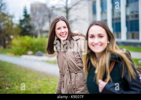 Two beautiful teenage students together outside in the school Stock Photo