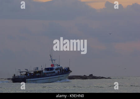 A charter party boat heads offshore for fishing near Port Aransas, Texas Stock Photo