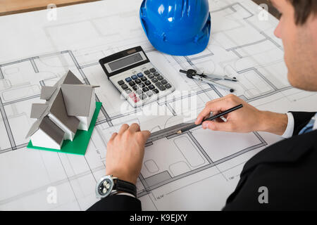 Close-up Of Male Architect Working On Blueprint In Office Stock Photo