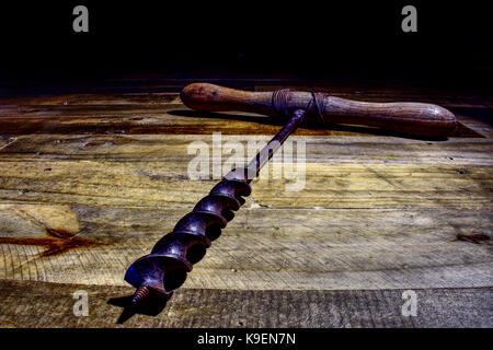 Carpentry drill. Old. Wooden background. Stock Photo