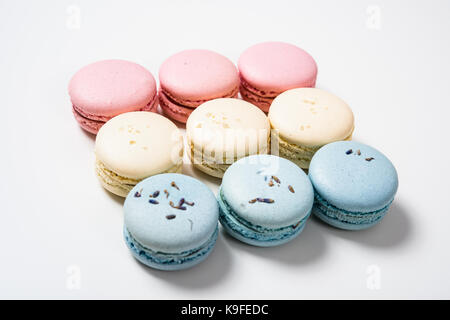 Colorful assorted macaroon cookies on white background, european desserts closeup shot Stock Photo