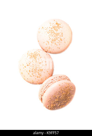 Three orange macaroon cookies isolated on white background, macro shot Stock Photo