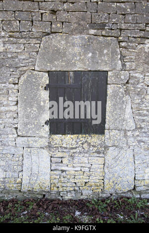 Ancient stones surrounding a shuttered window, Précy-le-Sec, Yonne, Bourgogne Stock Photo
