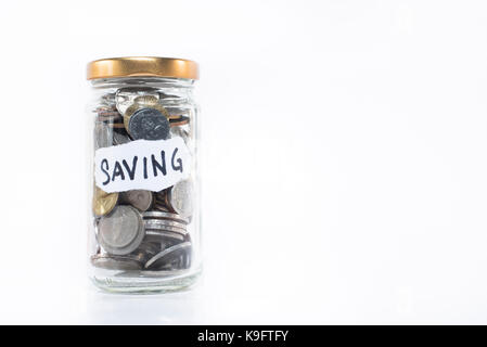 Coins in a glass jar with note written ' SAVING ' isolated on white background. free copy space. saving concept. Malaysia currency Stock Photo