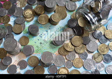 coins and glass jar on a map of "North America". Saving money for travel. saving concept and travel concept. Malaysia currency. Stock Photo
