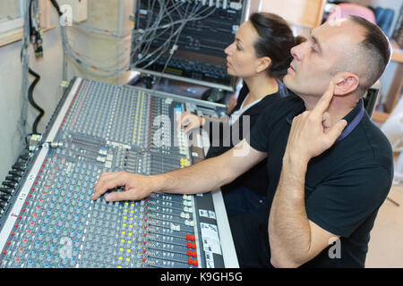 sound engineer and producer working together in studio Stock Photo