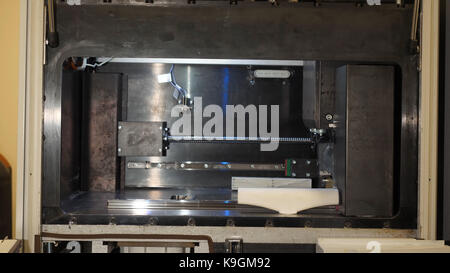 Automatic three dimensional 3d printer performs product creation. Modern 3D printing or additive manufacturing and robotic automation technology Stock Photo