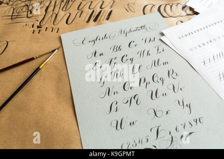 lettering, technique, drawing concept. english alphabeth written in italic style with elegant and smooth lines maded with help of thin tip of the brus Stock Photo