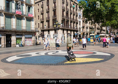 BARCELONA, SPAIN - SEPTEMBER 2: Joan Miro's Pla de Os mosaic in La Rambla on September 2, 2017 in Barcelona, Spain. Thousands of people walk daily on  Stock Photo