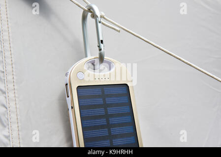 Hiking portable battery with solar panels on tent Stock Photo