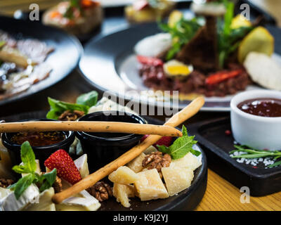 Italian chesse plate on black dish Stock Photo