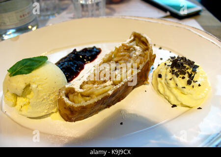 Apricot tarte tatin with vanilla ice cream on a white plate - Restaurant in Germany Stock Photo