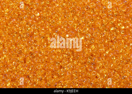 Close up of bright orange seed beads. High resolution photo. Stock Photo