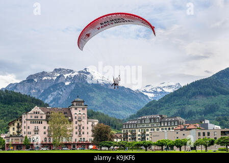 Interlaken, Switzerland - May 26, 2016: Tandem paragliding flights over the Swiss Alps in Interlaken, Switzerland. Stock Photo