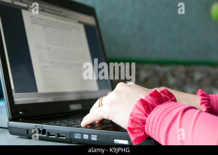 Image of female hands on the keys typing documents Stock Photo