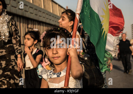 Erbil, Iraqi Kurdistan. 22nd Sep, 2017. A little girl carries the Kurdish flag outside the Franso Hariri Stadium in Erbil shortly before the last rally of the Kurdish Independence Referendum Campaign. Credit: Elizabeth Fitt/Alamy Live News Stock Photo