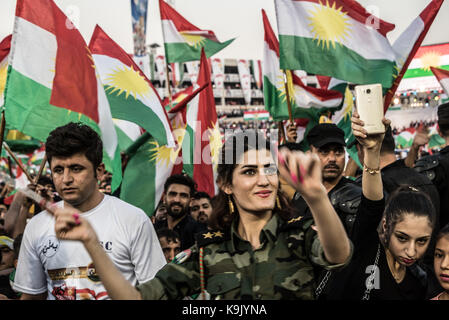 Erbil, Iraqi Kurdistan. 22nd Sep, 2017. A woman dances amid waving flags at the final pro Kurdish independence rally, held at the Franso Hariri Stadium in Erbil. 22nd September 2017. Credit: Elizabeth Fitt/Alamy Live News Stock Photo