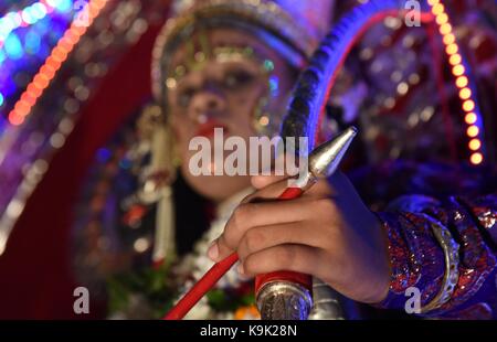 Allahabad, Uttar Pradesh, India. 23rd Sep, 2017. Allahabad: Indian artist dressed as Lord Rama sit in a tableau passing through a narrow street during a Dussehra festival procession in the old city in Allahabad on September 23, 2017. The ten-day long Hindu festival celebrates the victory of good over evil. Credit: Prabhat Kumar Verma/ZUMA Wire/Alamy Live News Stock Photo