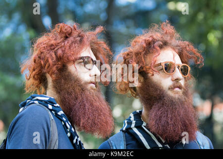 Milan, Italy - September 22, 2017: Fabrizio and Valerio Salvatori twins wear sunglasses during Armani's fashion show, photographing in the street Stock Photo