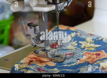 Threaded needle and bobbins spooled with thread of an antique