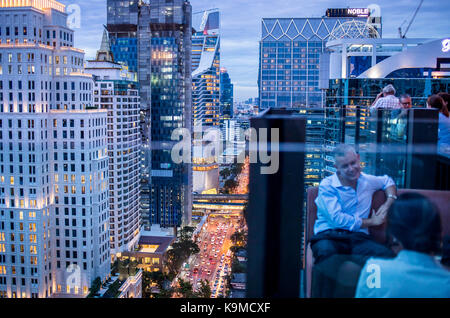 View from Char Rooftop Bar at Indigo Hotel, Skyline and Wireless Road at night, downtown, Bangkok, Thailand Stock Photo