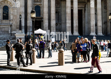 Armed Police Talking and Tourists Taking a Group Selfie Side by  Side Outside St.Pauls Cathedral In London United Kingdom
