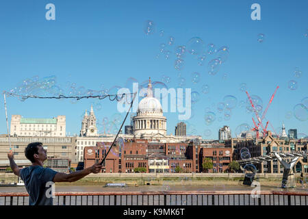 Street Performer Artist Making Large Soap Bubbles, South Bank London, United Kingdom Stock Photo