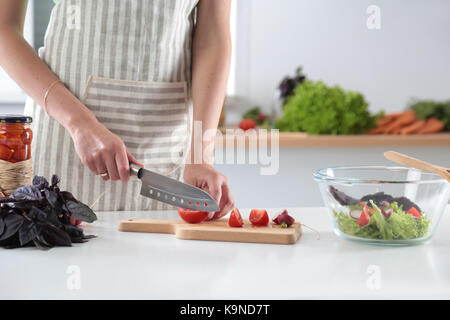 Cook's hands preparing vegetable salad - closeup shot. Stock Photo