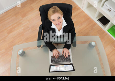 Young Happy Businesswoman Working On Laptop In Office Stock Photo