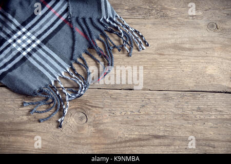 Grey checkered plaid on wooden background. Stock Photo