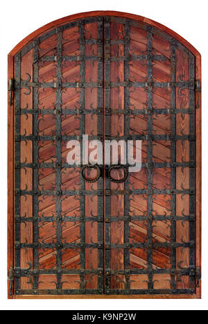 Antique wooden antique wooden doors with a forged iron grille and cross bars isolated on a white background. Stock Photo