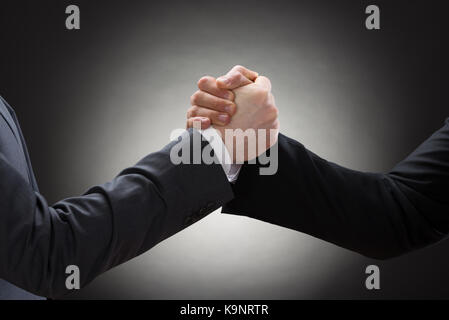 Close-up Of A Two Businessman Competing In Arm Wrestling Stock Photo