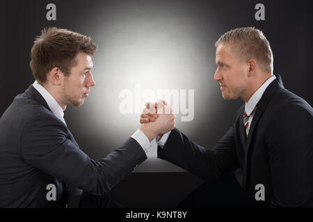 Close-up Of Two Young Businessman Competing In Arm Wrestling Stock Photo