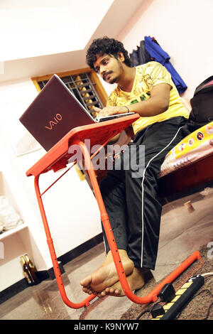 Young man using laptop on house Stock Photo
