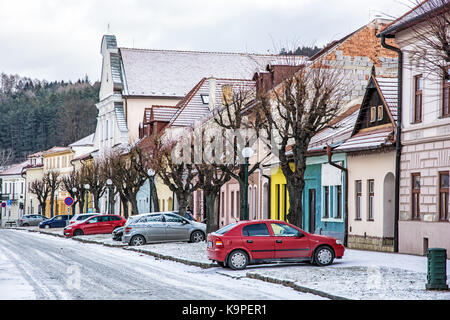 Traditional old buildings and parked cars in the street, Kezmarok city, Slovak republic. Travel destination. Stock Photo