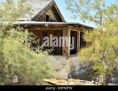 Ruined house in the desert. Decaying wood in the sun. Stock Photo