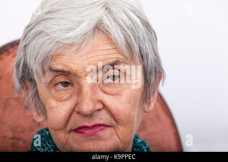 Portrait on a wrinkled old woman looking to the left. Stock Photo