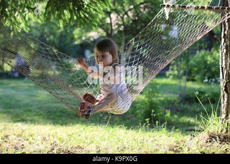 kid in hammock on nature Stock Photo