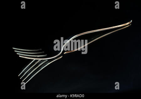 Fork highlighted against a black background Stock Photo