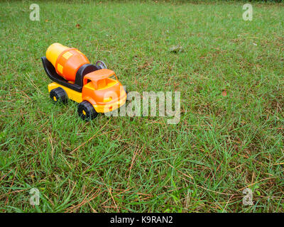 truck cement (concrete) mixer plastic toy on the grass in a garden Stock Photo